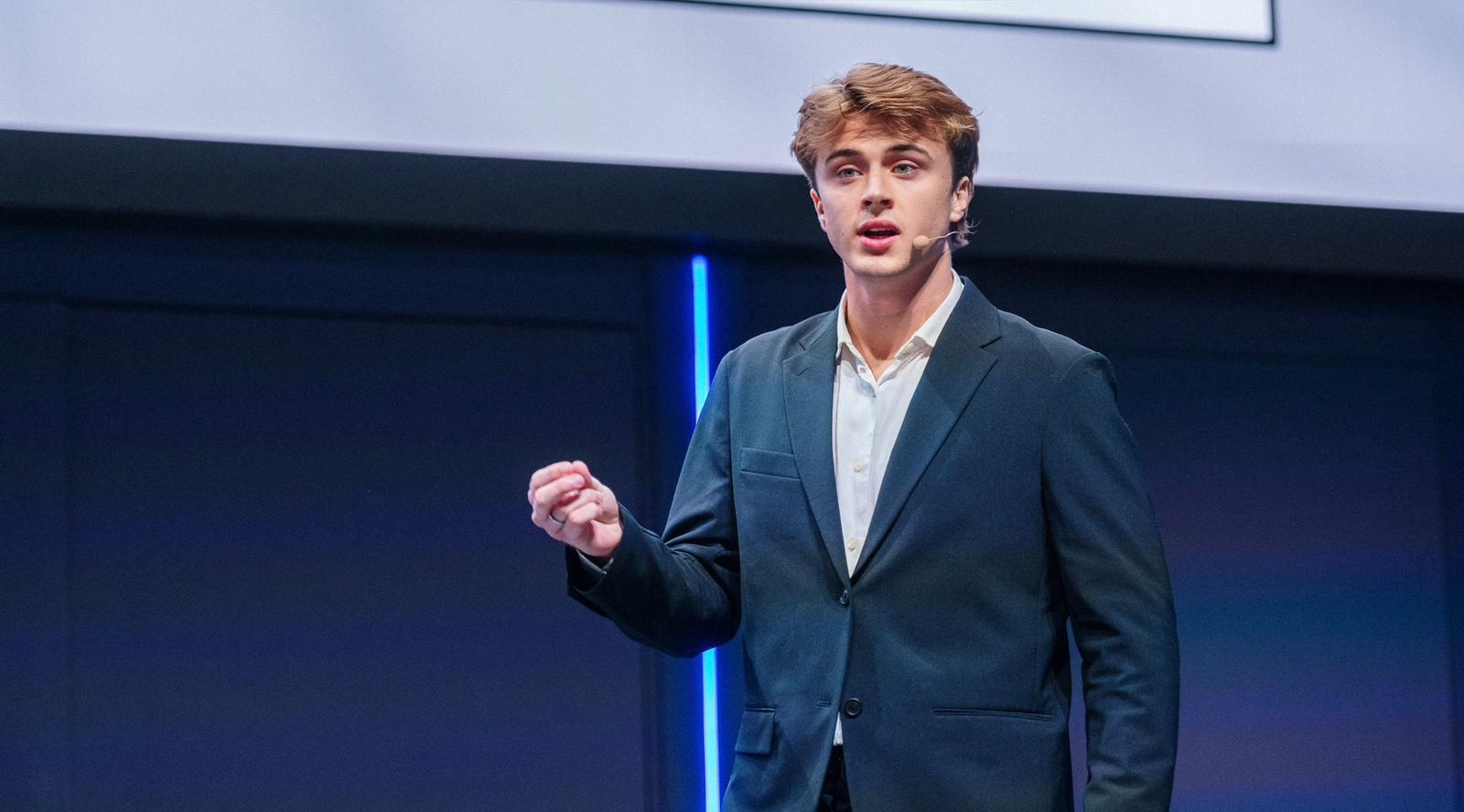 Lucas speaking on stage